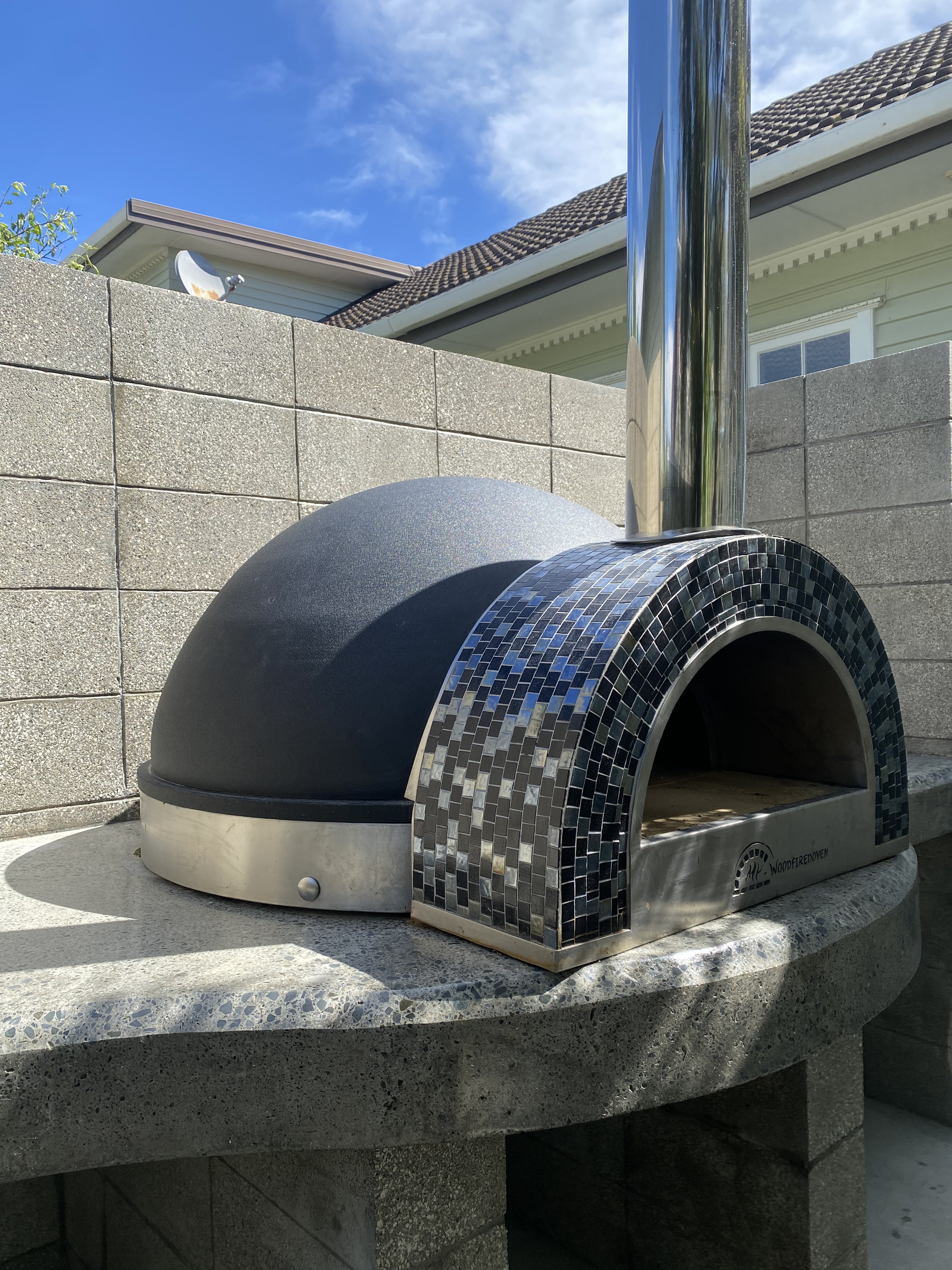 Outdoor kitchen with grill and seating