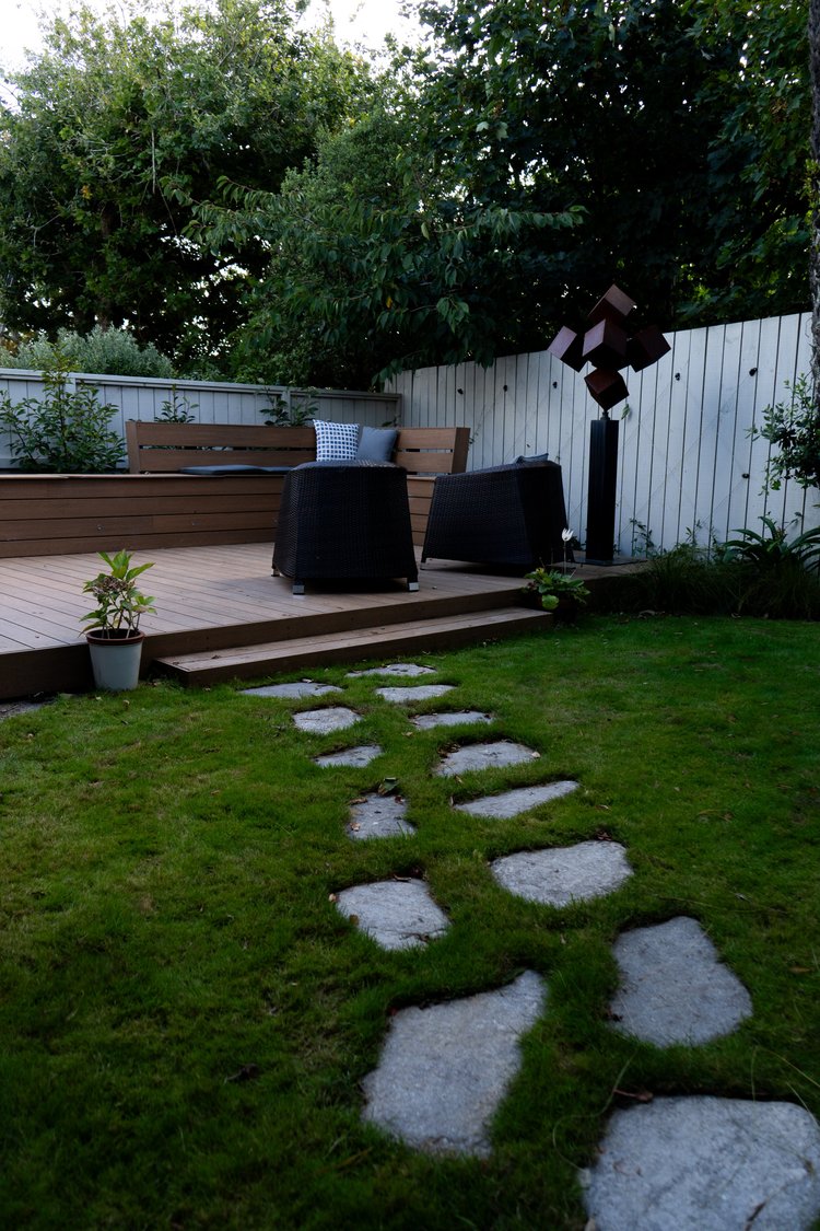 Tall view of the landscaped garden showing the deck and plantings.