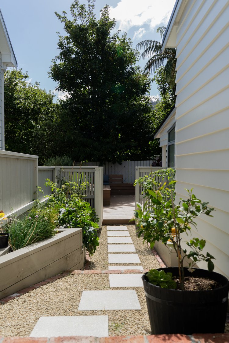 Close-up of a sculpture nestled within the garden foliage.